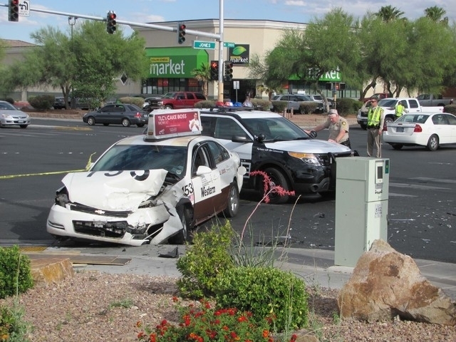 Las Vegas police work the scene after a crash shut down the intersection of Cheyenne Avenue and Jones Boulevard. A taxicab collided with a blue Mercedes sedan. (Greg Haas/Las Vegas Review-Journal)
