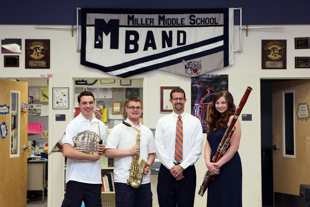 Band Director Jeff Williams, third from left, stands with his former students Ryan Everson, 17, from left, Connor O'Toole, 17, and Kelly Haines, 16, at Miller Middle School Thursday, June 5, 2014, ...