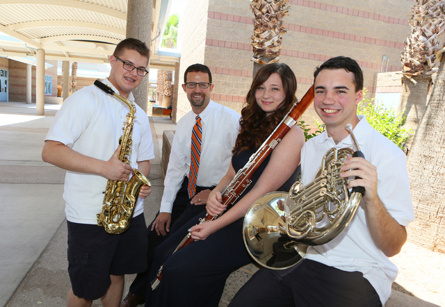 Band Director Jeff Williams, second from left, stands with his former students Connor O'Toole, 17, from left, Kelly Haines, 16, and Ryan Everson, 17, at Miller Middle School Thursday, June 5, 2014 ...