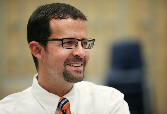 Band Director Jeff Williams listens to his former students speak during an interview at Miller Middle School Thursday, June 5, 2014, in Henderson. Williams' three former students, who are now in h ...