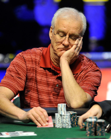 James Duke, of Houston, Texas, checks his cards during the final table of the Millionaire Maker event at the World Series of Poker tournament at the Rio hotel-casino on Tuesday, June 3, 2014. (Dav ...