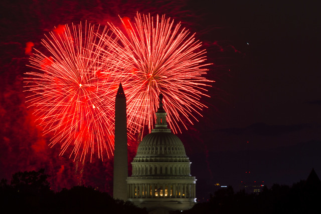 Fireworks illuminate the sky over the U.S. Capitol building and the Washington Monument during Fourth of July celebrations, on Friday, July 4, 2014, in Washington. (AP Photo/ Evan Vucci)