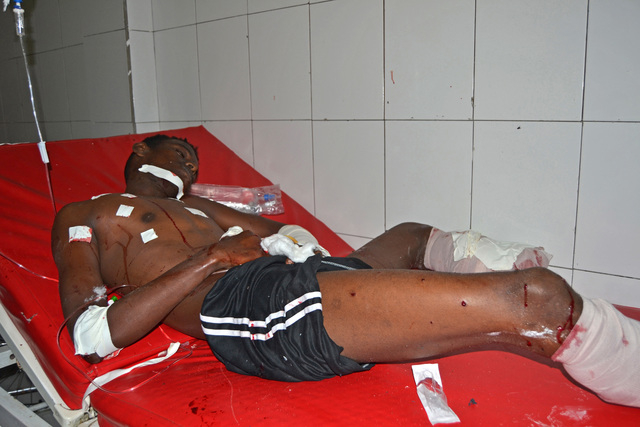 An injured Somali man is treated at Darul-Shifa hospital after he was wounded by a car bomb which exploded near the parliament, in Mogadishu, Somalia, Saturday, July 5, 2014. A Somali police offic ...