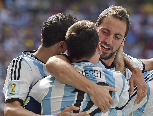 Argentina's Gonzalo Higuain, right, embraces Lionel Messi after he scored the opening goal against Belgium during the World Cup quarterfinal soccer match between Argentina and Belgium at the Estad ...