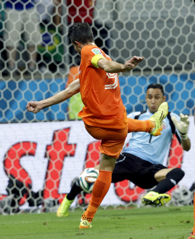 Costa Rica's goalkeeper Keylor Navas (1) stops a shot by Netherlands' Robin van Persie (9) during the World Cup quarterfinal soccer match between the Netherlands and Costa Rica at the Arena Fonte ...