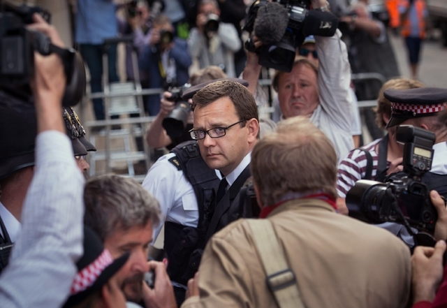 Former News of the World editor Andy Coulson, centre,  arrives at the Old Bailey court to receive his sentence, in London,  Friday, July 4, 2014. Coulson, 46, has been found guilty of being involv ...