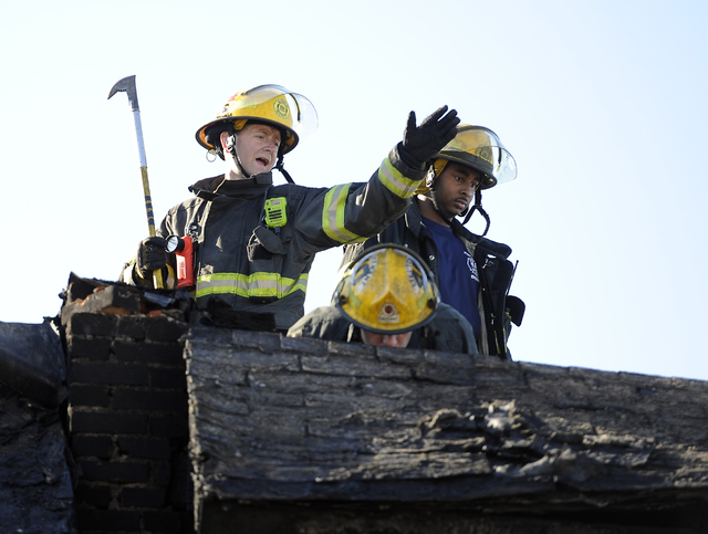 Philadelphia firefighters work on  burned row homes on Saturday, July 5, 2014, in Philadelphia.  A fast-moving fire in southwest Philadelphia early Saturday left four children dead and burned thro ...