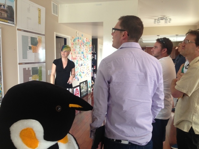 Bryan McArdle, who works for a nonprofit economic development organization in the Reno area, stands next to a stuffed penguin as he listens to guide Heidy Stamper discuss locations of Downtown Pro ...