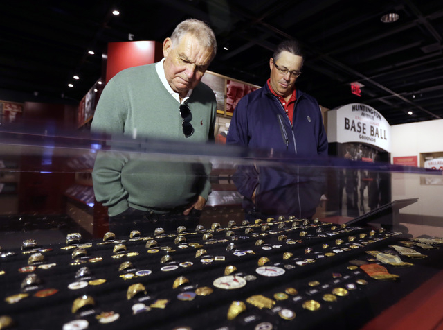 Former Atlanta Braves manager Bobby Cox, left, and former pitcher Greg Maddux look at an exhibit of World Series rings during their orientation visit at the Baseball Hall of Fame on Monday, March  ...