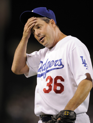 Los Angeles Dodgers' Greg Maddux wipes his head after errors by Rafael Furcal during the fifth inning in Game 5 of the National League baseball championship series agains the Philadelphia Phillies ...