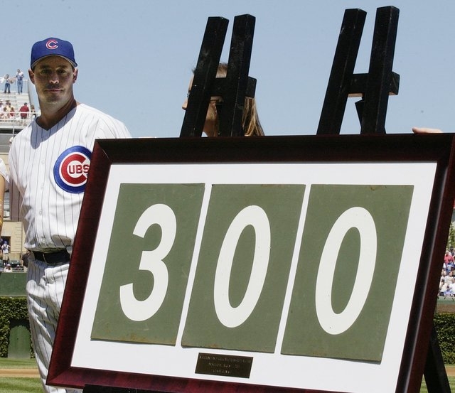 Chicago Cubs pitcher Greg Maddux looks at the framed 300 that was made up from Wrigley Field scoreboard numbers during a presentation prior to the game with the Los Angeles Dodgers, Sunday, Aug. 1 ...