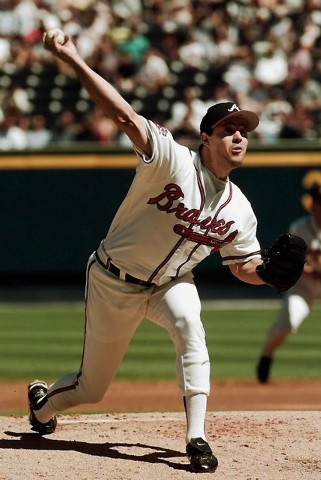 Atlanta Braves starting pitcher Greg Maddux hurls against the Houston Astros in the second inning Tuesday, Sept. 30, 1997 of Game 1 of  the National League Division Series at Turner Field in Atlan ...