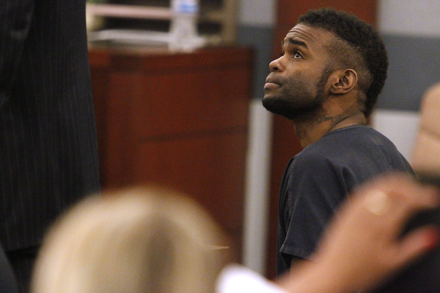 Jason Griffith looks up to his attorney during his sentencing hearing at the Regional Justice Center in Las Vegas Wednesday, July 23, 2014. Griffith was sentenced 10 years to life in prison for th ...