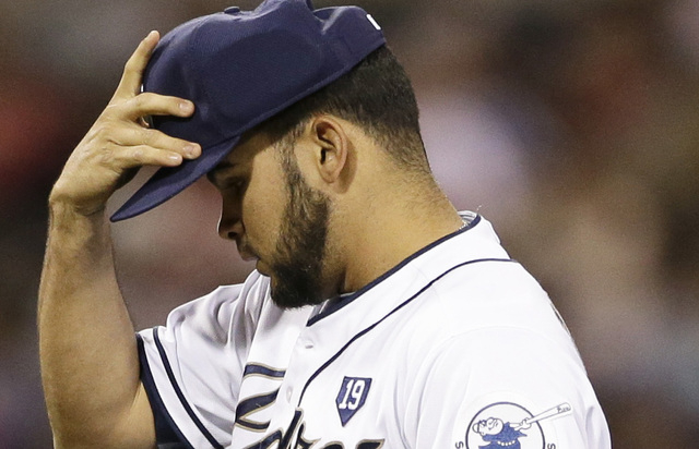 San Diego Padres relief pitcher Alex Torres adjusts his padded cap