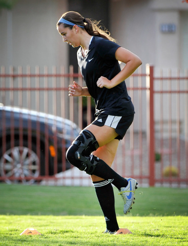 Jaydyn Nogues warms up with some dynamic warm up drills during her club soccer practice at Crossing Park on Monday, July 7, 2014. Nogues is returning to the soccer field after suffering a knee inj ...