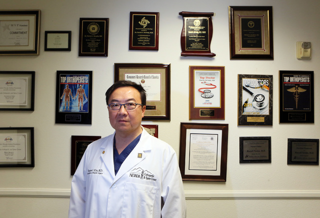 Dr. Thomas Kim stands in a hallway at Nevada Orthopedic and Spine Center Wednesday, July 9, 2014, in Las Vegas. Kim performs surgery on young athletes with a torn anterior cruciate ligament (ACL). ...