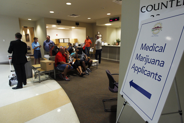 People gather to apply for medical marijuana establishments in the Community Development office at Henderson City Hall on July 17, 2014. (Jason Bean/Las Vegas Review-Journal)