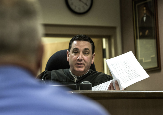 Clark County Family Court Judge William Voy speaks to Bruce Burgess, superintendent of Caliente Youth Center, during a hearing at Family Courts and Services Center on Thursday, July 24, 2014. Ju ...