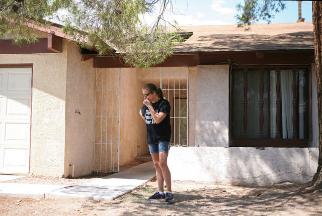 Julie Ramos is overcome with emotion while standing outside her home before talking to the media during a news conference on Autumn Street Wednesday, July 30, 2104, in Las Vegas. The Ramos family ...