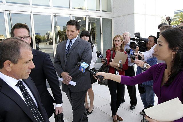 Longtime Family Court Judge Steven Jones, third from left, declines to talk to the news media Thursday, Nov. 1, 2012, outside the Lloyd George Federal Courthouse in Las Vegas after pleading not gu ...