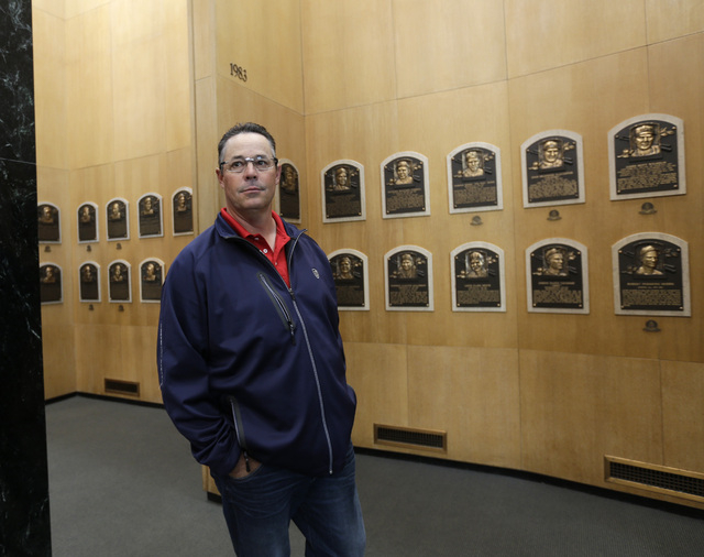 Former Atlanta Braves pitcher Greg Maddux walks through the Plaque Gallery during his orientation visit at the Baseball Hall of Fame on Monday, March 24, 2014, in Cooperstown, N.Y. Maddux will be  ...