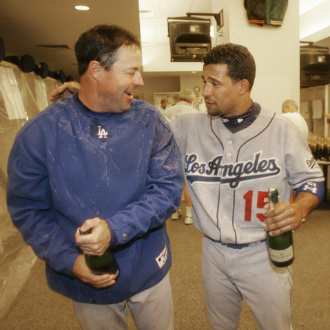 Los Angeles Dodgers pitcher Greg Maddux, left, celebrates with teammate Rafael Furcal after the team clinched a playoff berth with a 4-2 win over the San Francisco Giants in a baseball game in San ...