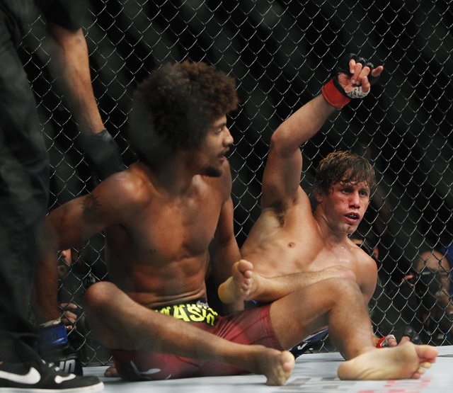 Urijah Faber, right, celebrates after earning a submission victory over Alex Caceres during UFC 175 at the Mandalay Bay Events Center in Las Vegas on Saturday, July 5, 2014. (Jason Bean/Las Vegas  ...
