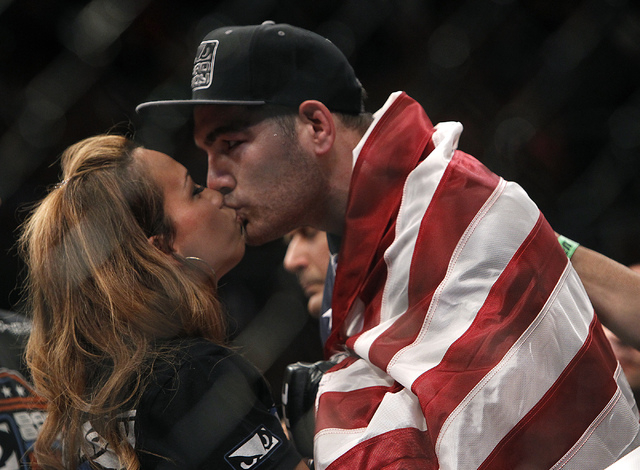 Chris Weidman gets a kiss from his wife after defeating Lyoto Machida during UFC 175 at the Mandalay Bay Events Center in Las Vegas on Saturday, July 5, 2014. Weidman defeated Machida by unanimous ...