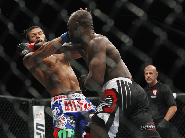 Uriah Hall, left, hits Thiago Santos during UFC 175 at the Mandalay Bay Events Center in Las Vegas on Saturday, July 5, 2014. (Jason Bean/Las Vegas Review-Journal)