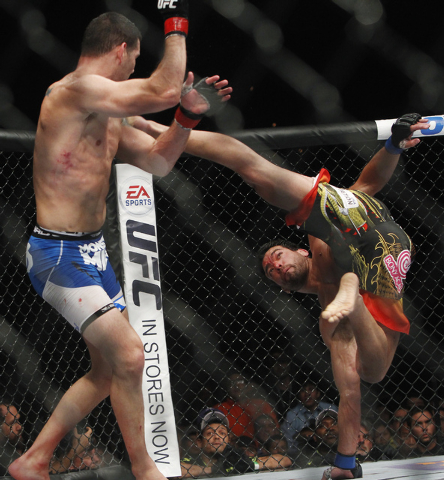 Chris Weidman, left, avoids a kick from Lyoto Machida during UFC 175 at the Mandalay Bay Events Center in Las Vegas on Saturday, July 5, 2014. (Jason Bean/Las Vegas Review-Journal)