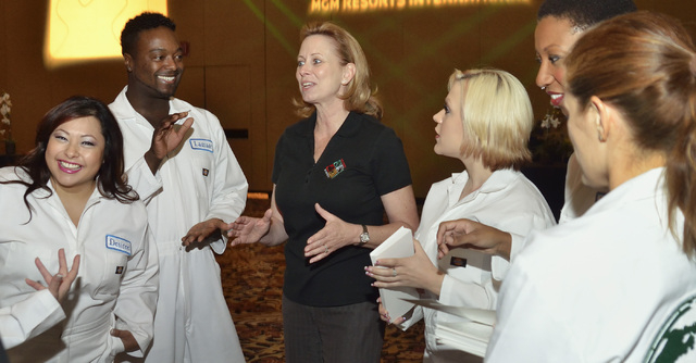 Patty Coaley, center, executive director of diversity and inclusion for MGM Resorts International, talks with volunteers from MGM properties before they take the stage as a dance team for a show d ...