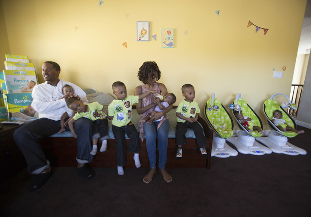 Deon Derrico, left, and his wife Evonne with their seven of their nine children at their home in North Las Vegas on Monday, March 24, 2014. Evonne Derrico gave birth to quintuplets on Sept. 6. (Je ...