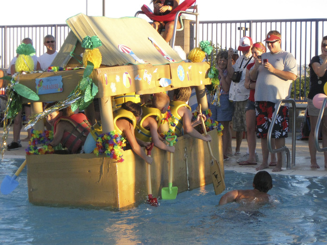The tiki-hut inspired Fun In the Sun cardboard boat, powered by six rowers and by far the larges boat in the contest, attempts to make its way across the pool during the annual Cardboard Boat Rega ...