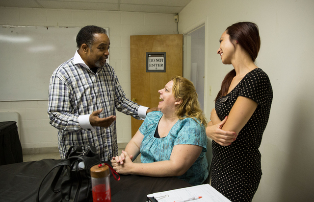 Welton T. Smith III, with Greater Evergreen Missionary Baptist Church, left, talks with Valerie Fuller, center, and Amanda Obinque (cq), both with Three Square food bank, at the church, located at ...