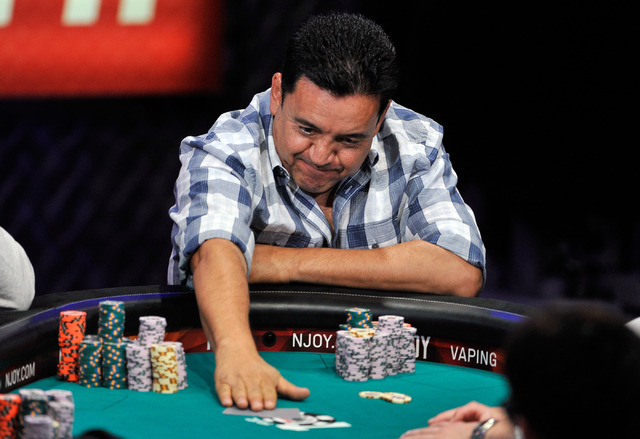 Luis Velador pushes his cards to the dealer during day 7 of the World Series of Poker Main Event at the Rio hotel-casino on Monday, July 14, 2014. (David Becker/Las Vegas Review-Journal)