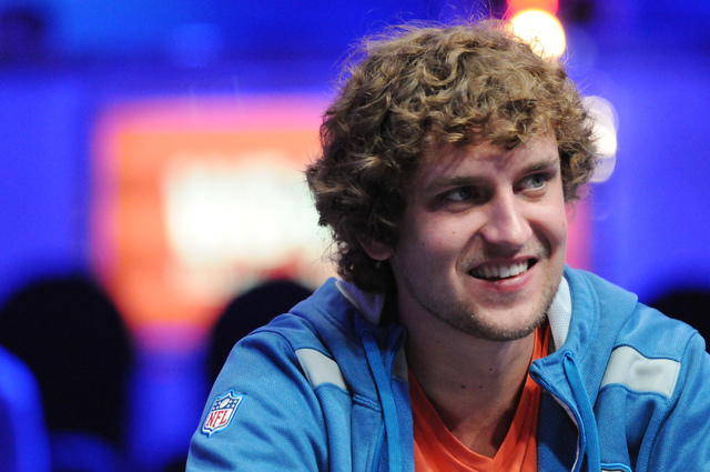 Ryan Riess, 2013 World Series of Poker champion, plays on the main stage inside the the Amazon room during the 2014 World Series of Poker event at the Rio Convention Center in Las Vegas Saturday,  ...