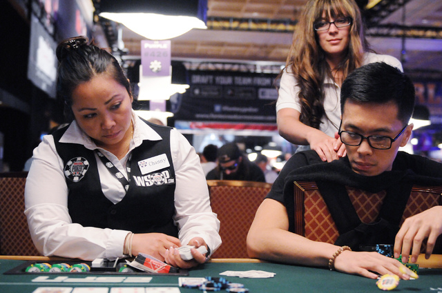 Poker player Nam Le, right, gets a back rub from massage therapist Rachel Harper as he competes during the 2014 World Series of Poker event at the Rio Convention Center in Las Vegas Saturday, July ...
