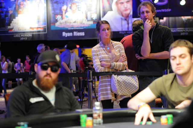Chelsea Dobbins, left, watches her boyfriend Christopher Chapman compete during the 2014 World Series of Poker event with Chapman's cousin Eduardo Kohlmann at the Amazon room inside the Rio Conven ...