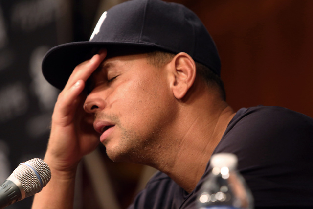 FILE - In this Aug. 5, 2013 file photo, New York Yankees' Alex Rodriguez, with his hand to his head, talks during a news conference before the Yankees played the Chicago White Sox in a baseball ga ...
