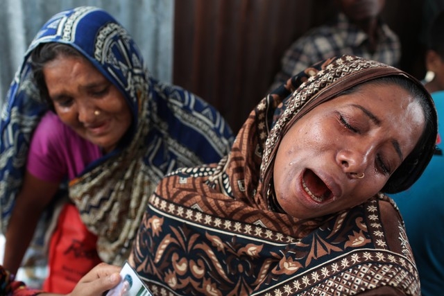 A Bangladeshi woman Mahomuda, right, cries for her missing mother, victim of a ferry capsize, in Munshiganj district, Bangladesh, Tuesday, Aug. 5, 2014. Rescuers were struggling Tuesday to locate  ...