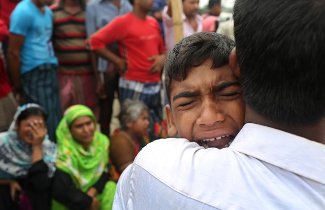 A Bangladeshi boy cries for his mother, missing after a ferry they were travelling in capsized in the River Padma in Munshiganj district, Bangladesh, Tuesday, Aug. 5, 2014. Rescuers were strugglin ...
