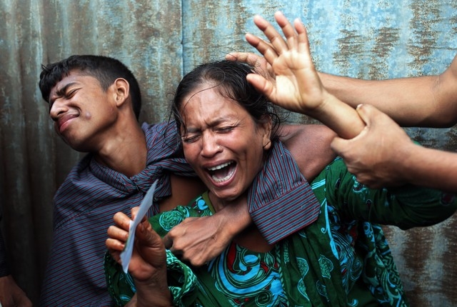 Bangladeshi woman Munni, whose daughters are missing, cries as rescuers search the River Padma after a passenger ferry capsized in Munshiganj district, Bangladesh, Monday, Aug. 4, 2014. A passenge ...