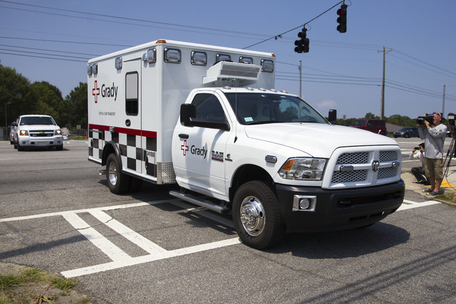 An ambulance leaves Dobbins Air Reserve Base transporting Nancy Writebol, the second American missionary stricken with Ebola, Tuesday, Aug. 5, 2014, in Marietta, Ga. Writebol was admitted to Atlan ...