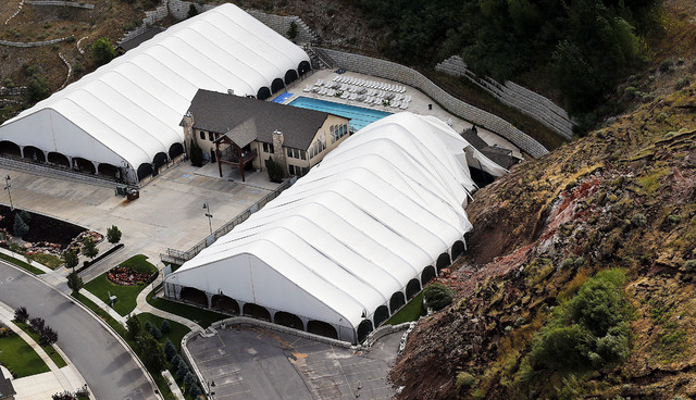 The Eagleridge Swim and Tennis Club works is damaged following a landslide in a hillside community of North Salt Lake, Utah, Tuesday, Aug. 5, 2014. One home has been destroyed and at least a dozen ...