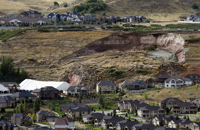 This Tuesday, Aug. 5, 2014 photo shows the area of a landslide in a hillside community of North Salt Lake, Utah. One home has been destroyed and at least a dozen others have been evacuated. (AP Ph ...