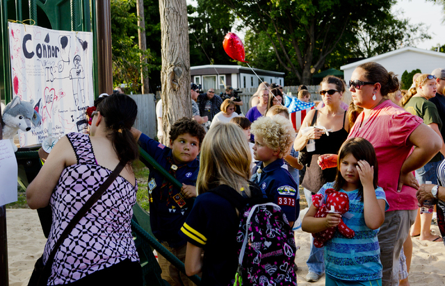 Community members write their thoughts on a memorial dedicated to Michael Connor Verkerke, 9, who was stabbed and killed Monday, Aug. 4, by a 12 year-old-boy, who is currently facing a murder cha ...