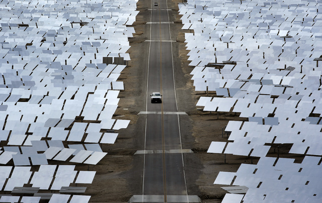 A truck drives through an array of mirrors at the Ivanpah Solar Electric Generating System near Primm on Aug. 13, 2014. The site uses over 300,000 mirrors to focus sunlight on boilers' tubes atop ...