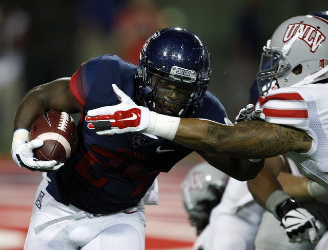 Arizona running back Terris Jones-Grigsby (24) runs for 45 yards against UNLV during the first half of an NCAA college football game, Friday, Aug. 29, 2014, in Tucson, Ariz. (AP Photo/Rick Scuteri)