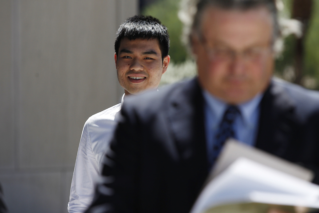Darren Phua, left, walks to Lloyd George Federal Courthouse in Las Vegas with his attorney David Chesnoff for his arraignment Tuesday, Aug. 5, 2014. Phua's father Paul is the alleged ringleader of ...