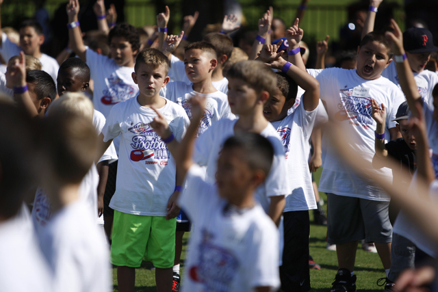 Children participate during the Royal Purple Las Vegas Bowl Youth Football Clinic at Bill "Wildcat" Morris Rebel Park at UNLV Tuesday, Aug. 5, 2014. (Erik Verduzco/Las Vegas Review-Journal)